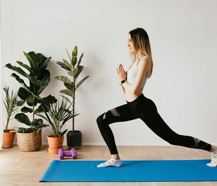 A calm home corner with a yoga mat and a plant.